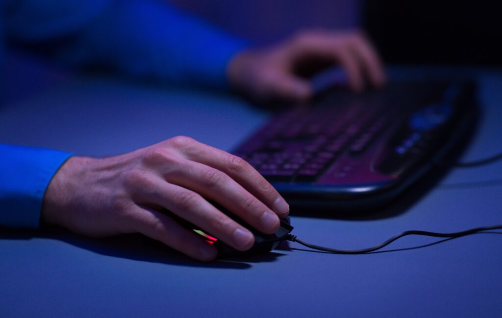 Man playing video games on desktop pc at home